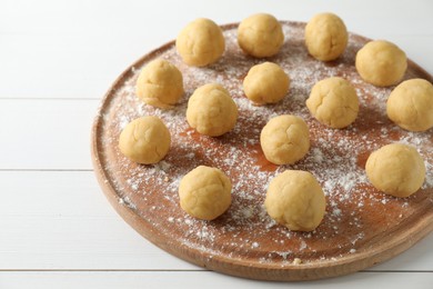 Photo of Shortcrust pastry. Raw dough balls on white wooden table