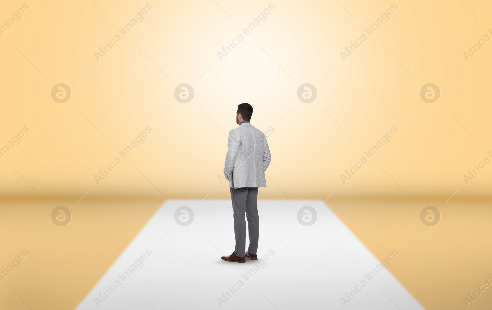 Image of Man standing in front of pale yellow wall