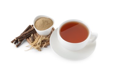 Photo of Aromatic licorice tea in cup, dried sticks of licorice root and powder isolated on white