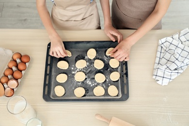 Mother and her daughter with cookie dough in kitchen