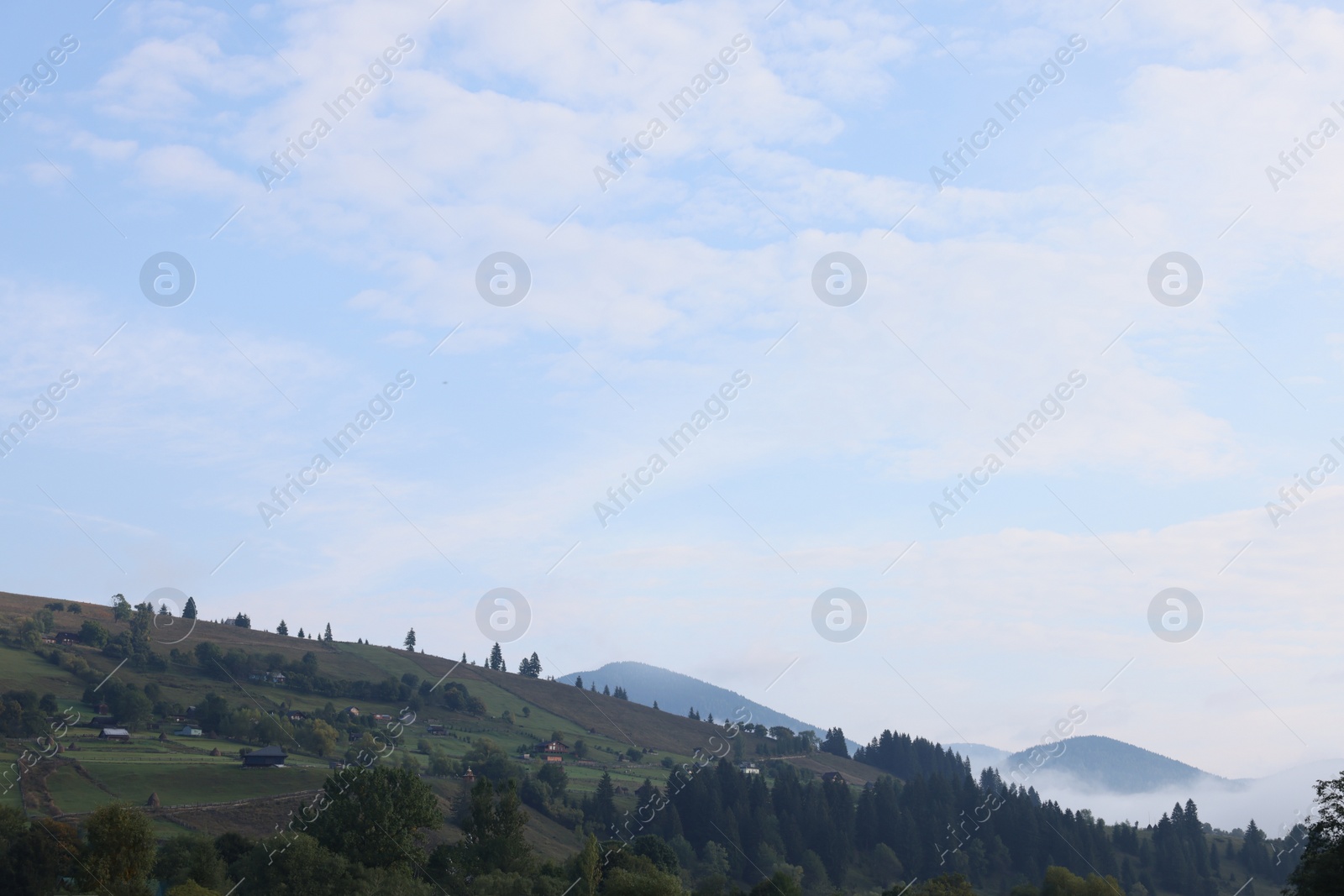 Photo of Beautiful view of village on mountain slopes in morning