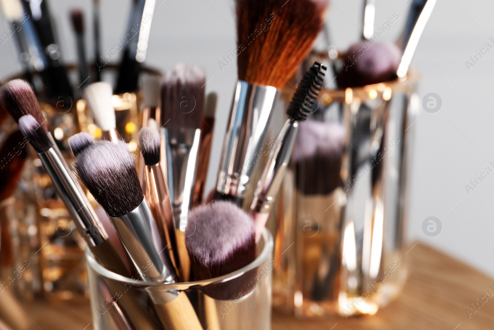 Photo of Set of professional brushes on wooden table, closeup