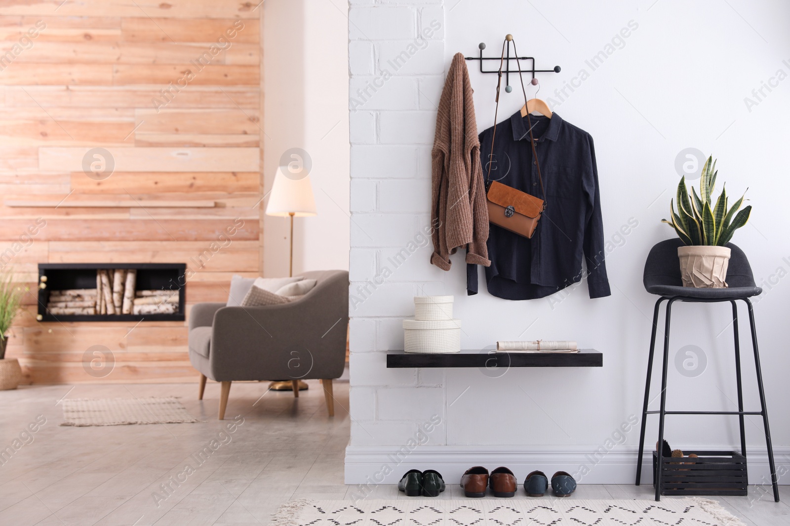 Photo of Hallway interior with stylish furniture, clothes and accessories