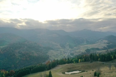 Aerial view of beautiful mountain landscape with forest at sunrise