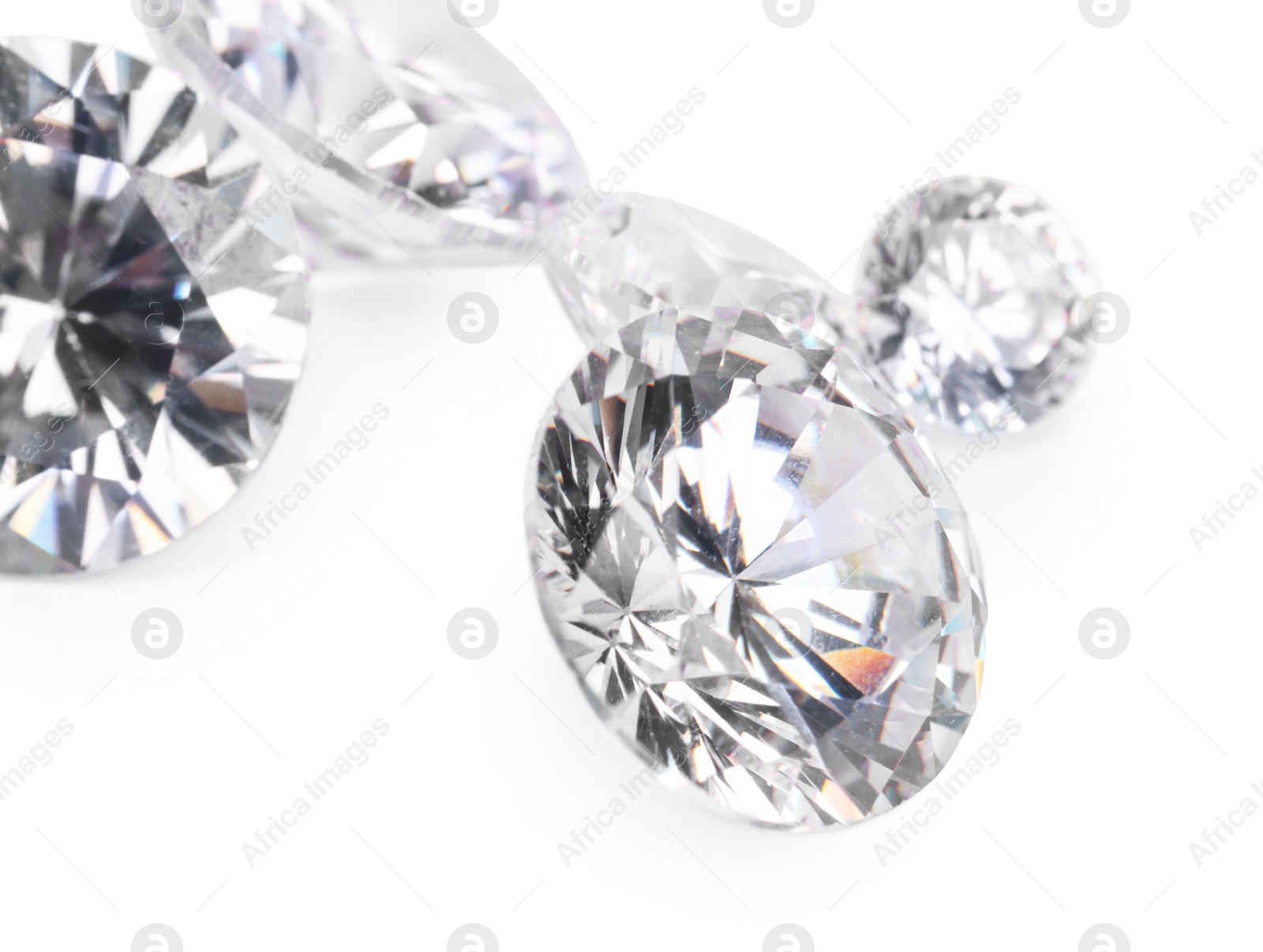 Photo of Many beautiful shiny diamonds isolated on white