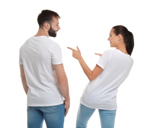 Photo of Young couple in t-shirts on white background. Mockup for design