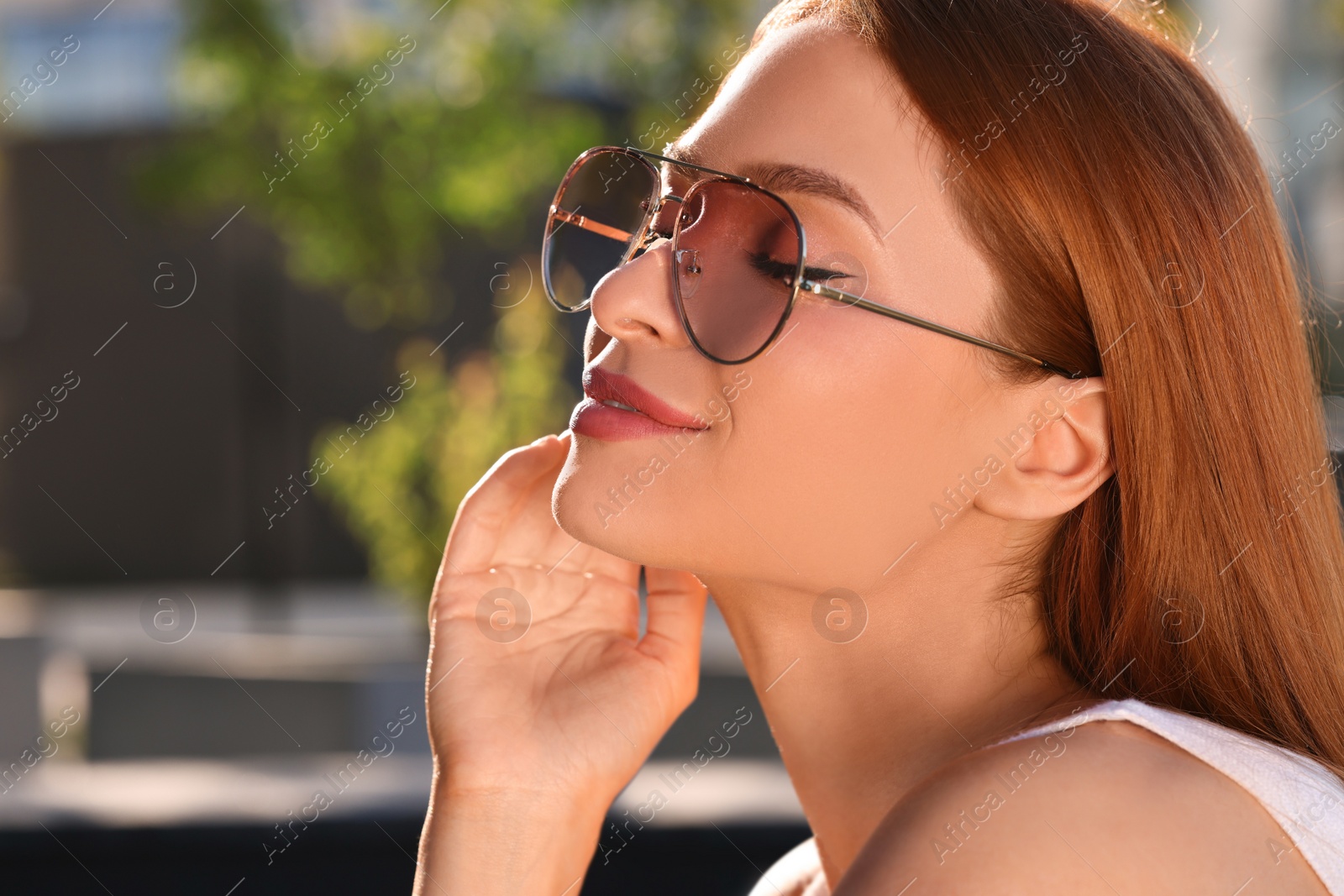 Photo of Beautiful woman in sunglasses outdoors, space for text