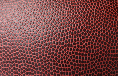 Photo of Leather American football ball as background, closeup