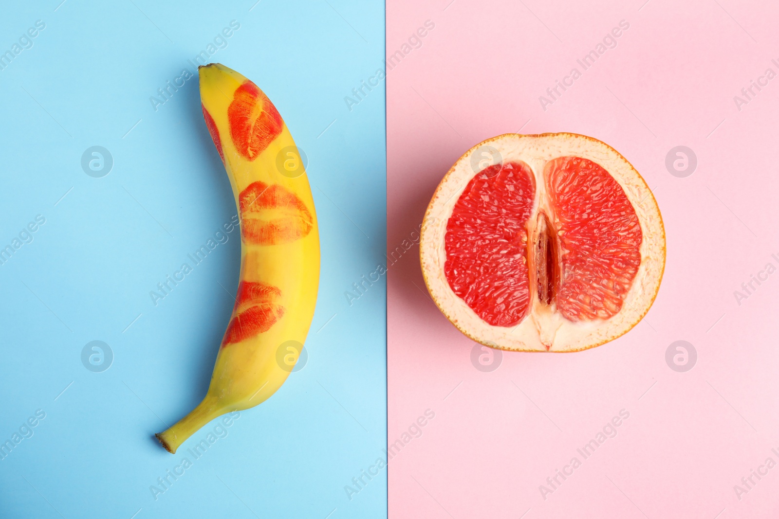 Photo of Flat lay composition with fresh banana and grapefruit on color background. Sex concept