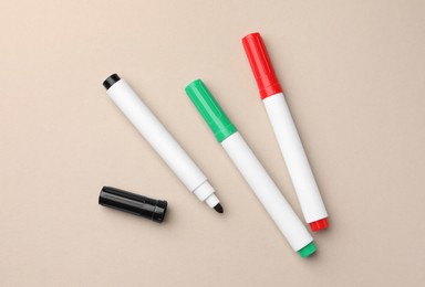 Photo of Bright color markers on beige background, flat lay