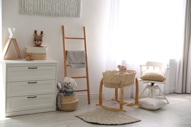 Photo of Cute children's room interior with wooden decorative ladder