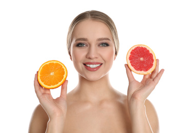 Young woman with cut orange and grapefruit on white background. Vitamin rich food