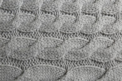 Photo of Grey knitted fabric with beautiful pattern as background, top view