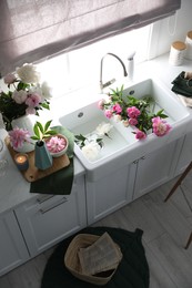 Beautiful kitchen counter design with fresh peonies, above view