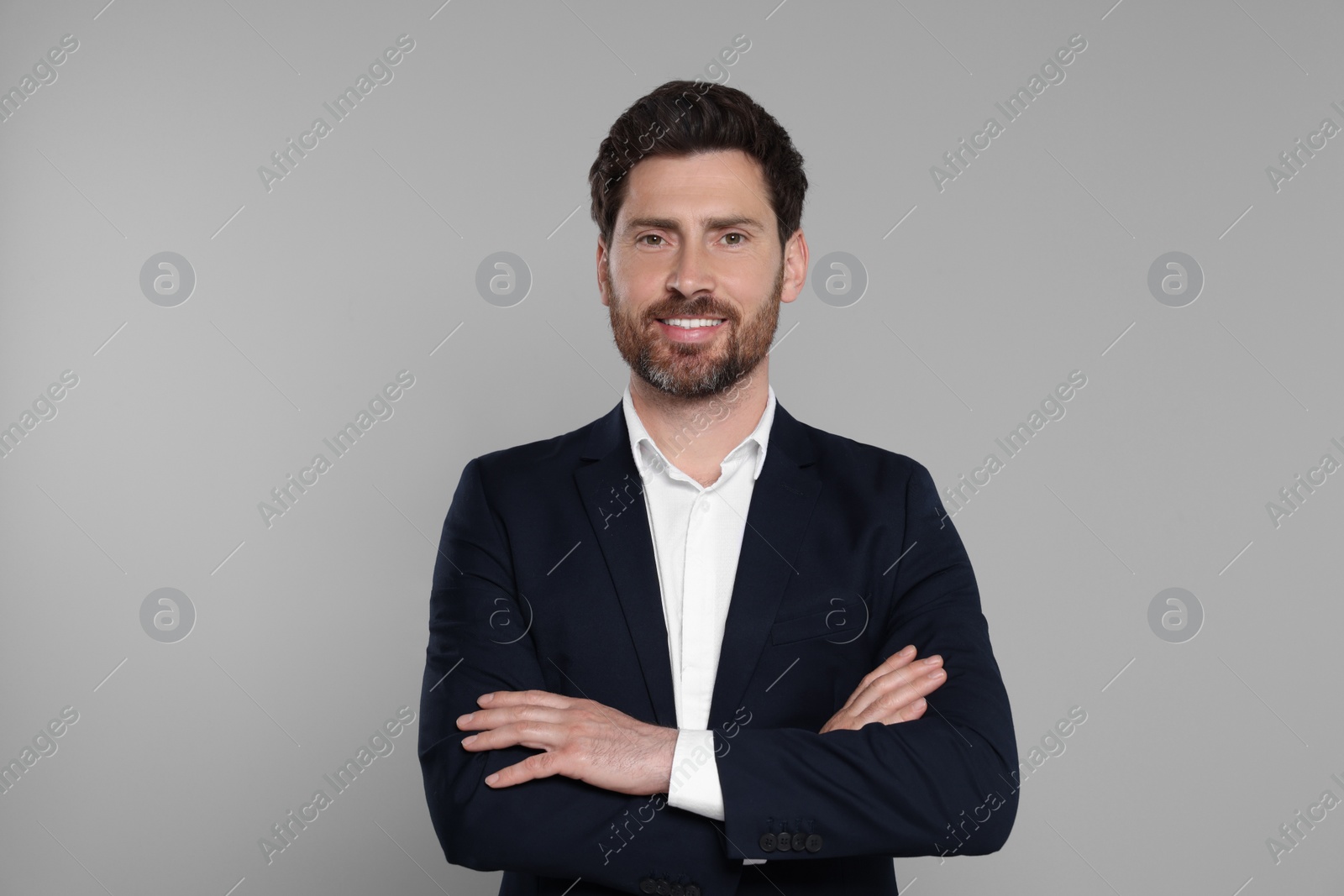 Photo of Happy real estate agent on grey background