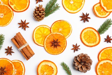 Photo of Flat lay composition with dry orange slices, anise stars, cinnamon sticks and fir cones on white background