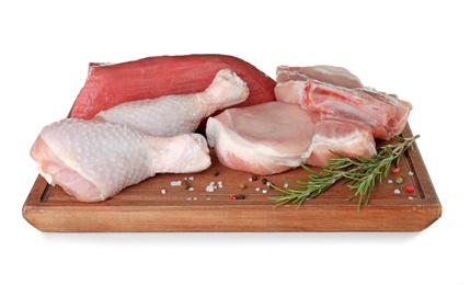 Wooden board with fresh raw meat, rosemary and spices on white background