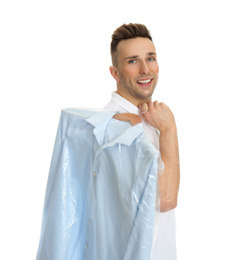 Photo of Man holding hanger with shirt in plastic bag on white background. Dry-cleaning service