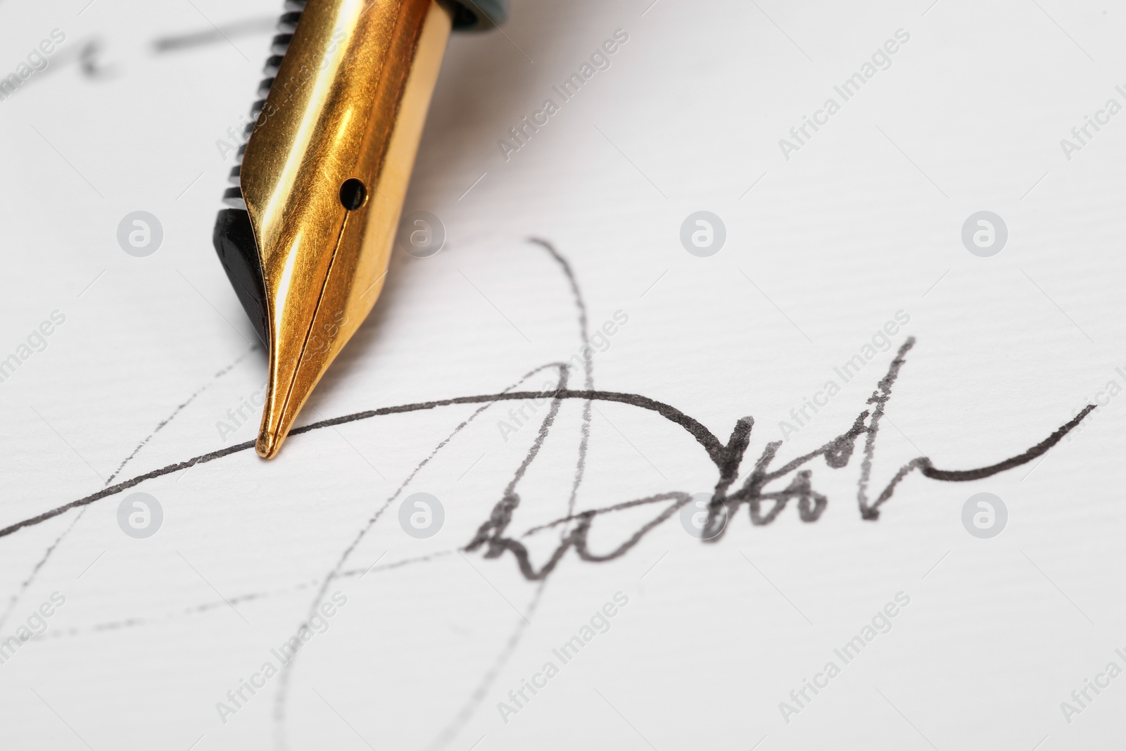 Photo of Sheet of paper with fountain pen and signature, closeup