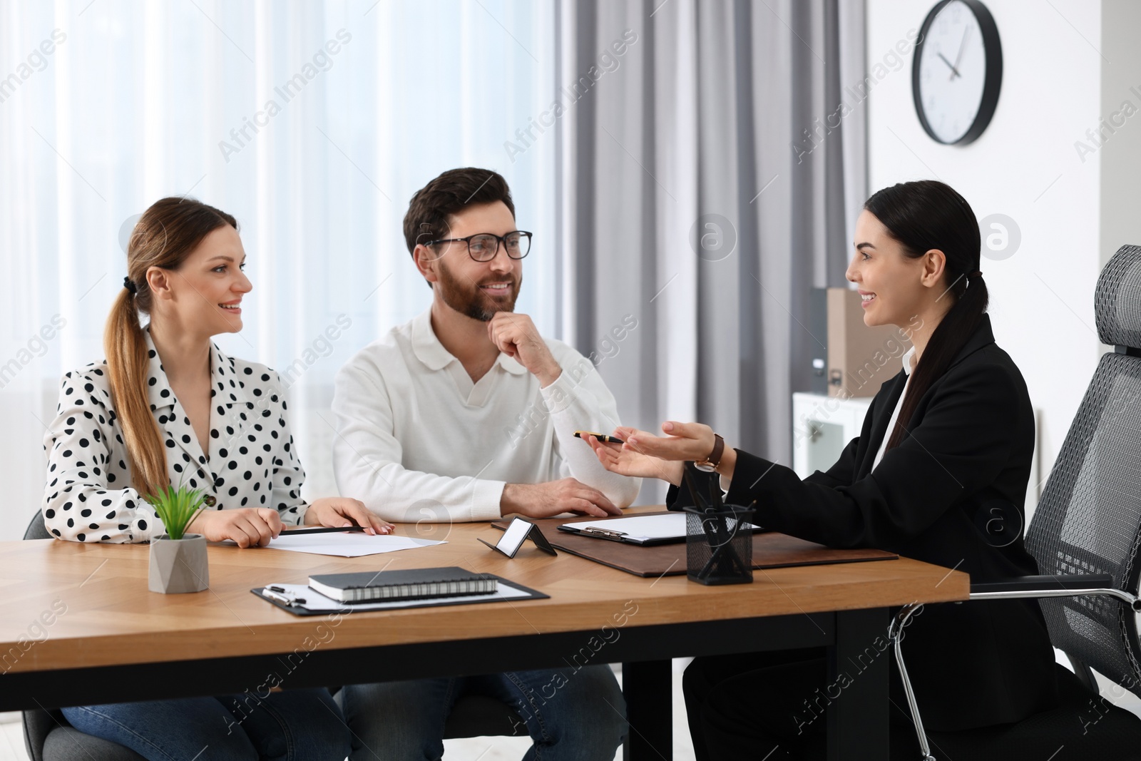 Photo of Couple having meeting with lawyer in office