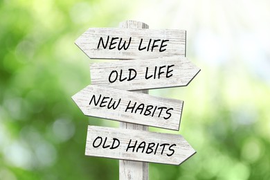 Image of Alcohol addiction: what to choose - life with old bad habits or new good ones? Wooden signpost with different directions on blurred green background