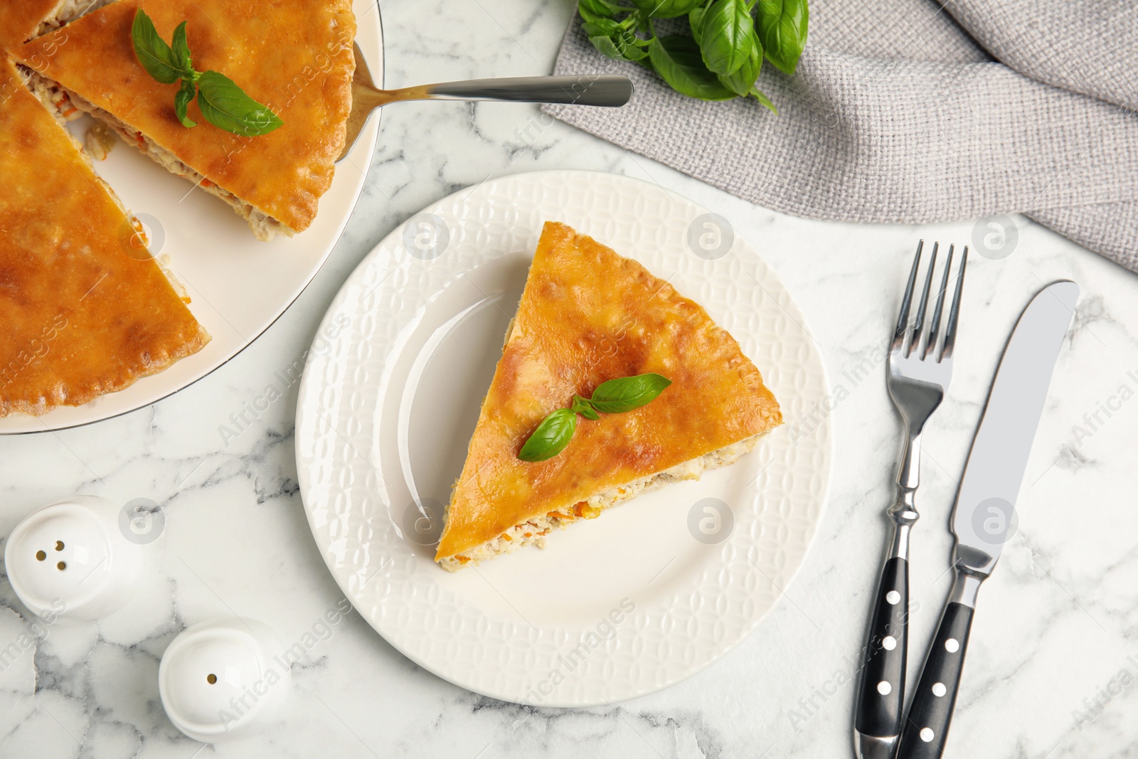 Photo of Delicious pie with meat and basil on white marble table, flat lay