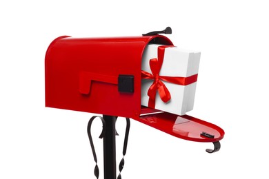 Photo of Red mailbox with Christmas gift isolated on white. Sending present by mail