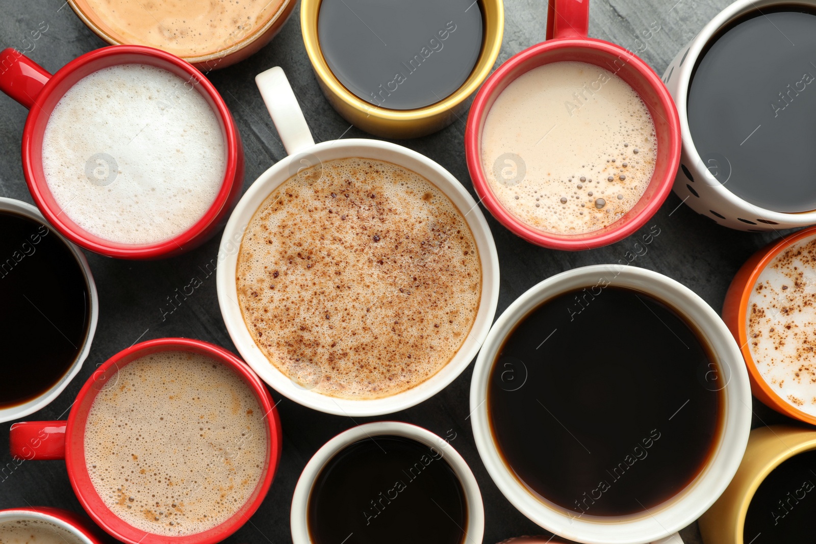 Photo of Many cups of different coffees on table, flat lay