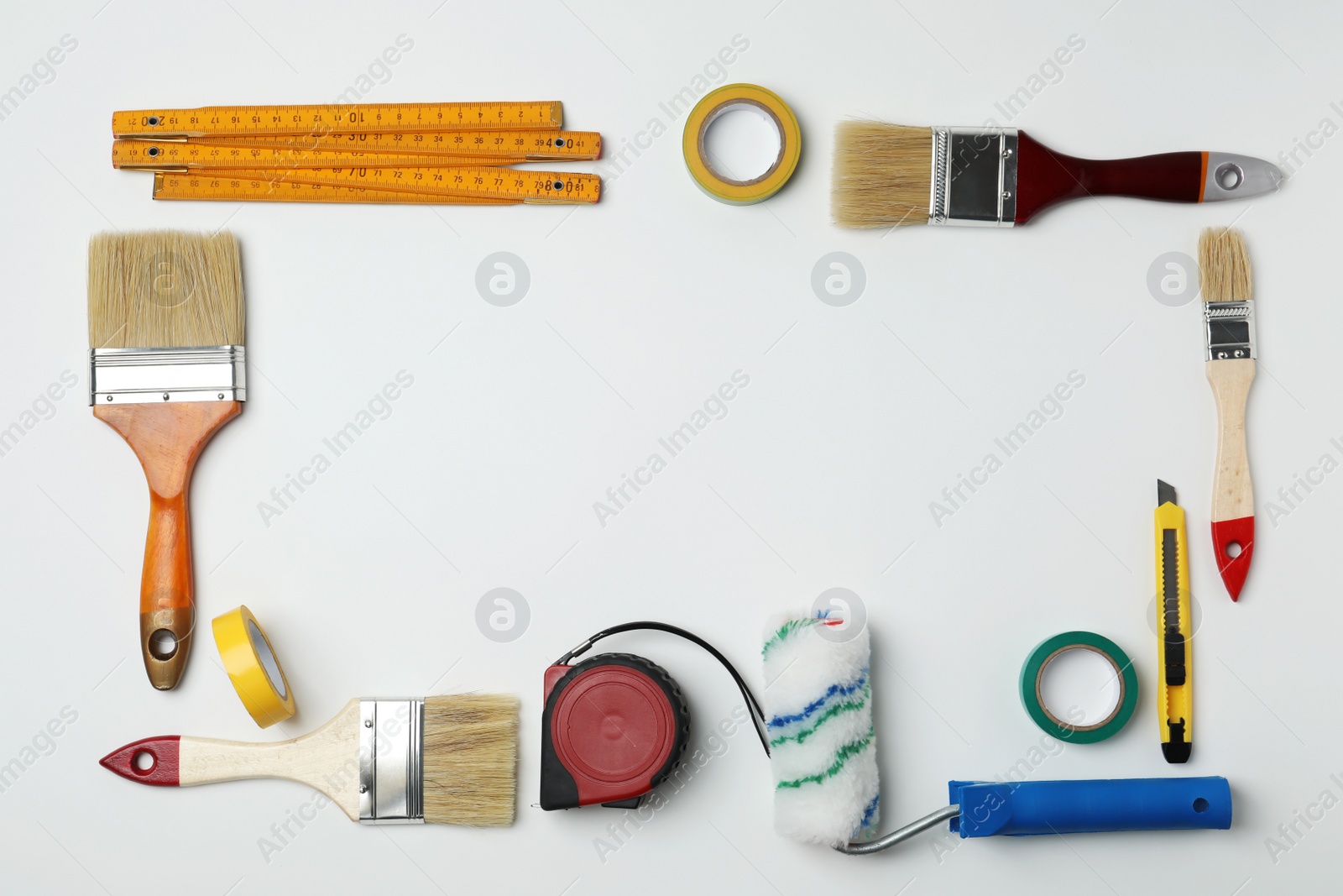 Photo of Set of decorator's tools on light background, flat lay