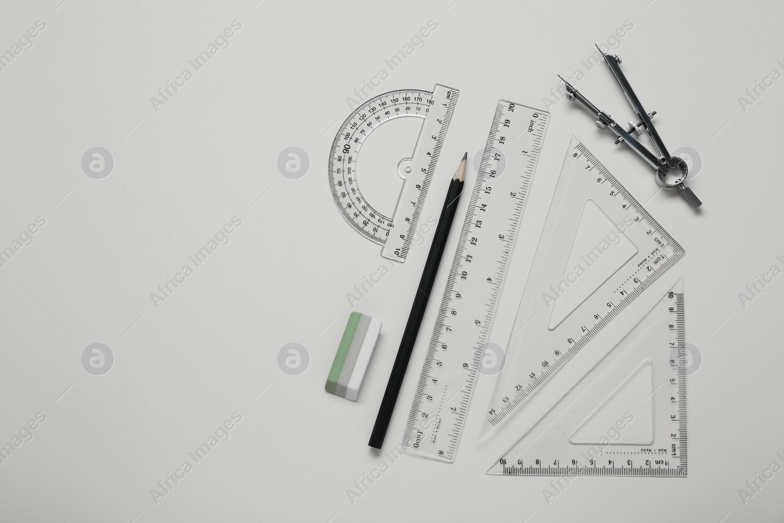 Photo of Different rulers and compass on yellow background, flat lay. Space for text