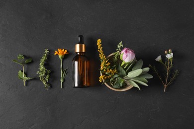 Photo of Bottle of essential oil, different herbs and flowers on black table, flat lay