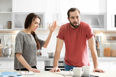 Photo of Young couple having argument in kitchen