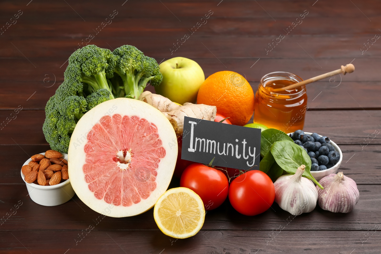 Photo of Card with word Immunity and fresh products on wooden table