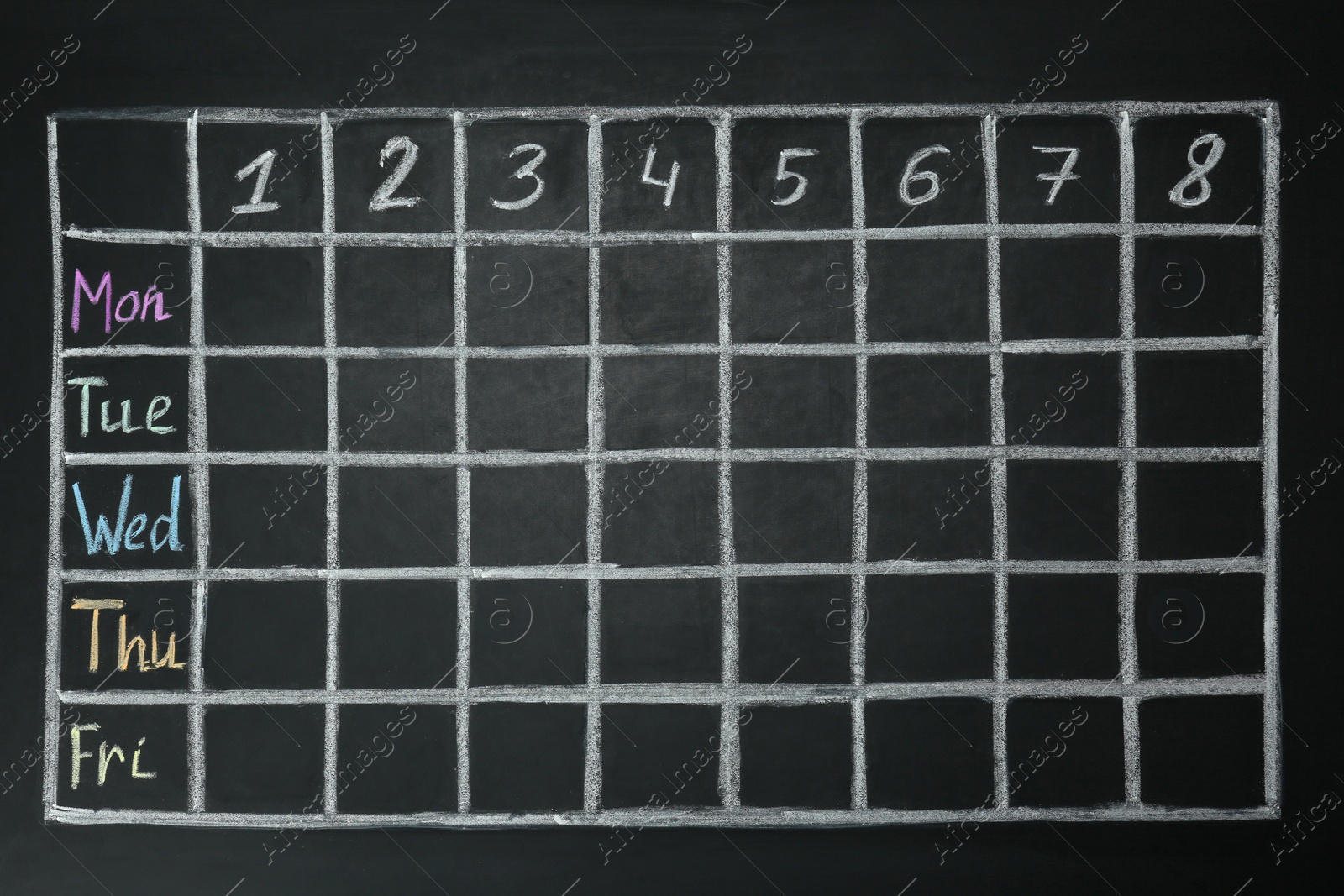 Photo of Weekly school timetable drawn on black chalkboard