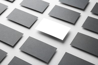 Blank business cards on light grey background. Mockup for design