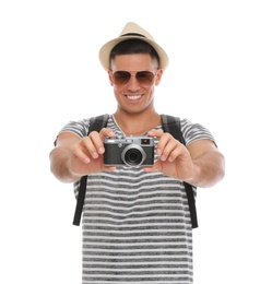 Man with straw hat taking picture on white background. Summer travel