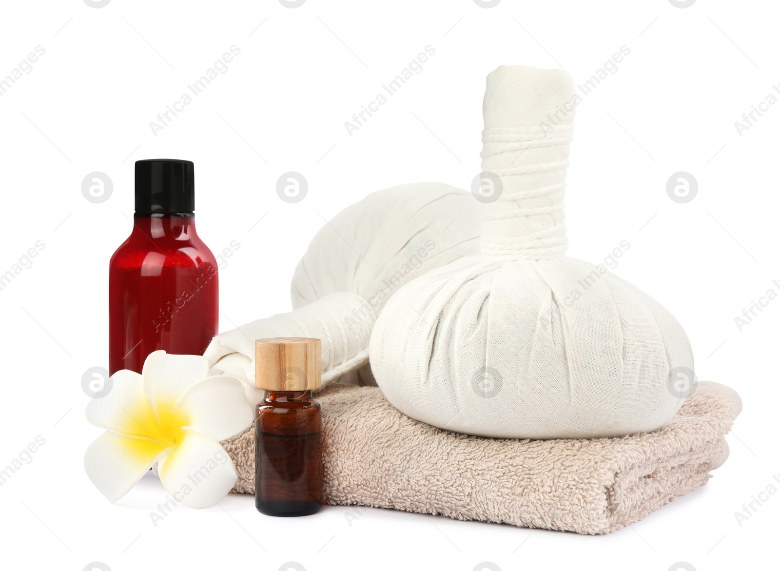 Photo of Herbal massage bags, towel and cosmetic products on white background. Spa supply