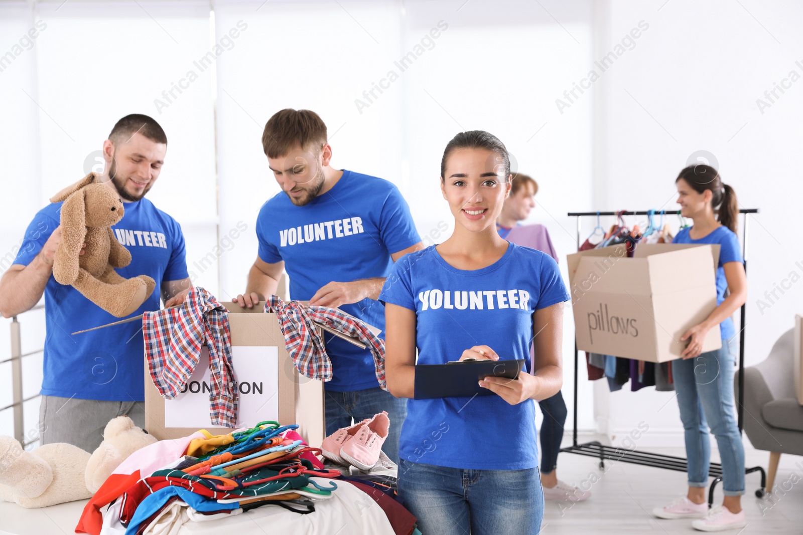 Photo of Team of young volunteers collecting donations indoors