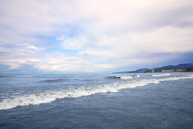 Photo of Picturesque view of sea with waves on cloudy day