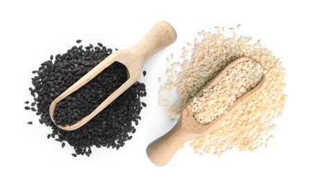 Image of Set with different sesame seeds on white background, top view