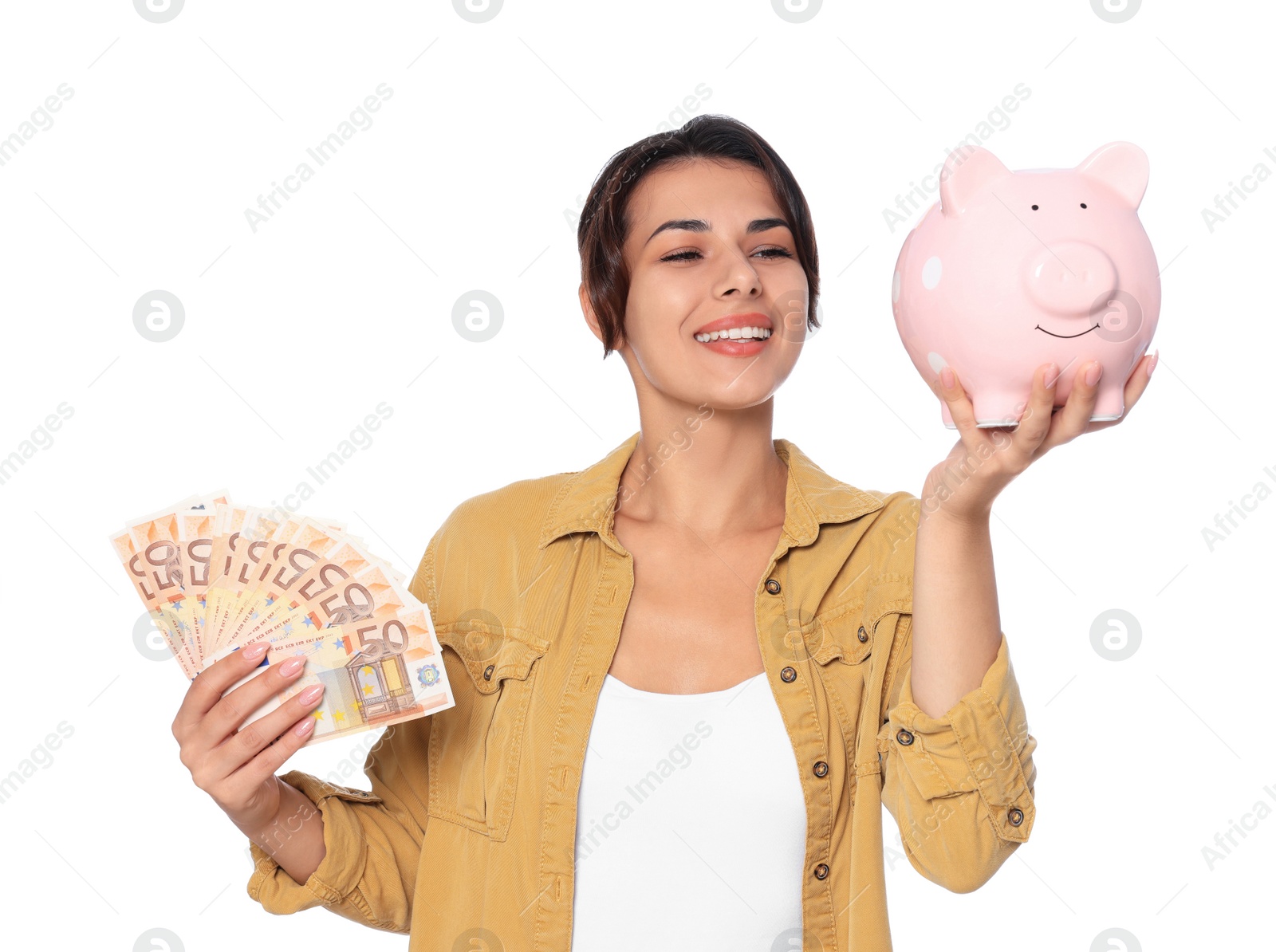 Photo of Young woman with money and piggy bank on white background