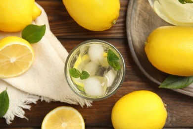 Photo of Cool freshly made lemonade and fruits on wooden table, flat lay