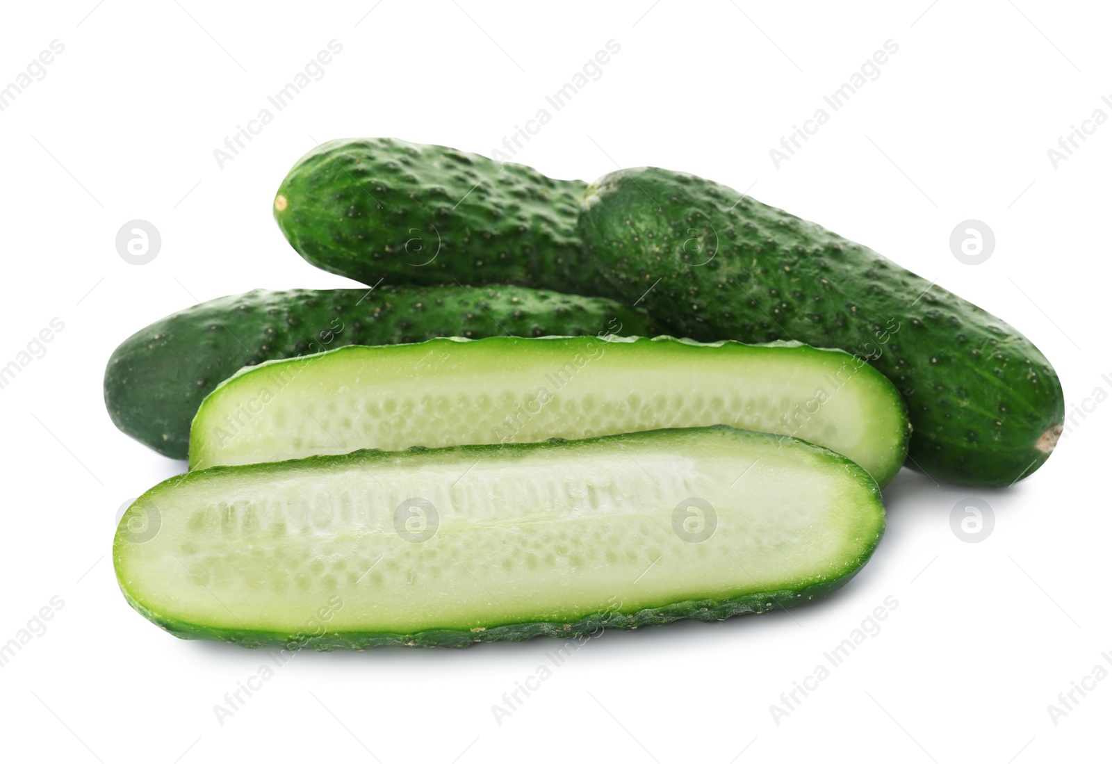 Photo of Whole and cut cucumbers on white background