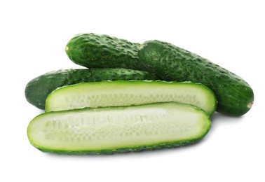 Photo of Whole and cut cucumbers on white background