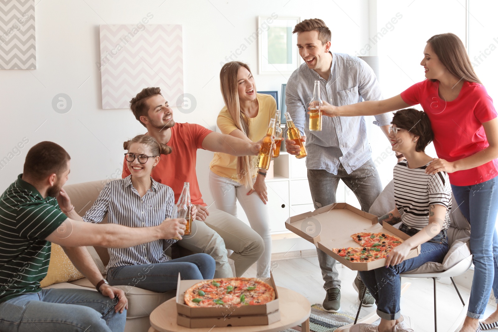 Photo of Young people having fun party with delicious pizza indoors