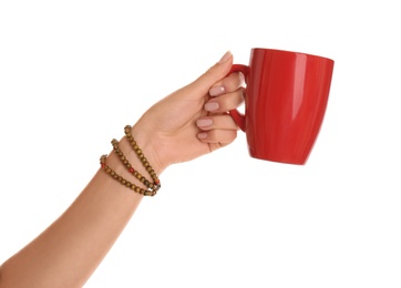 Woman holding elegant red cup on white background, closeup