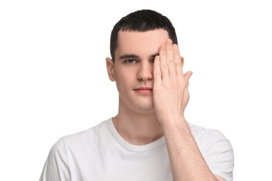 Photo of Young man covering his eye on white background