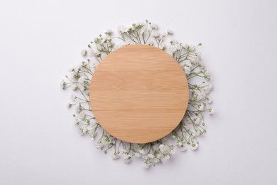 Photo of Blank wooden board with beautiful gypsophila flowers on white background, top view. Space for text