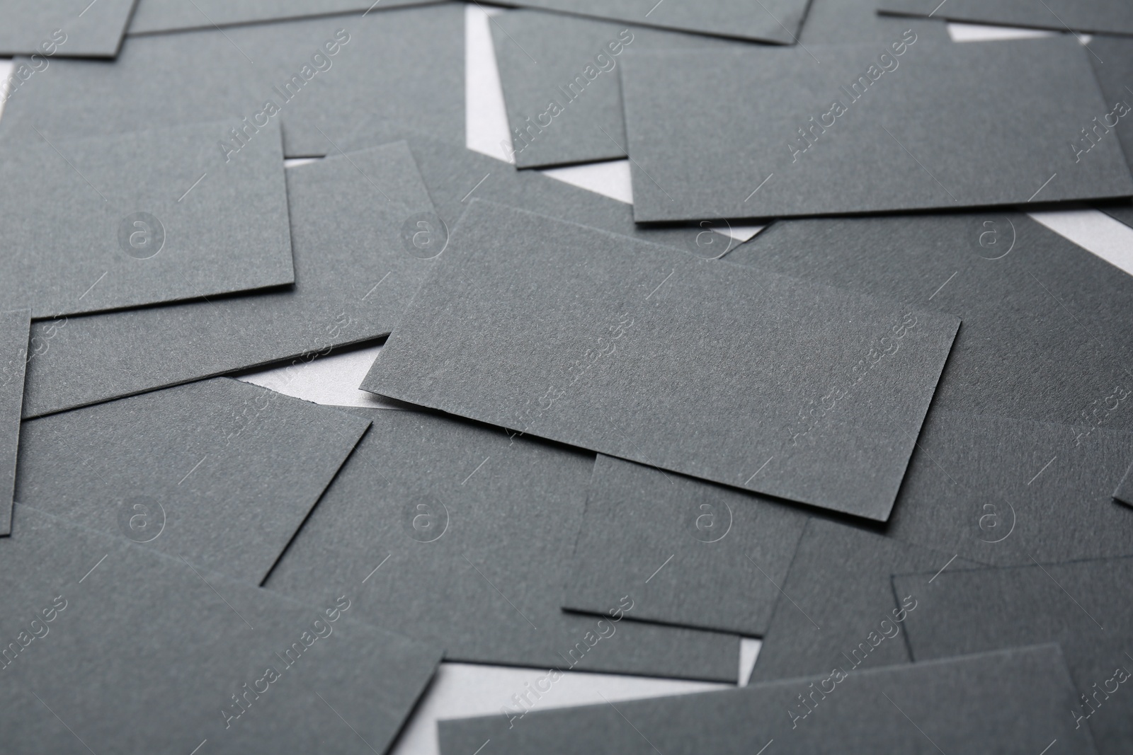 Photo of Blank black business cards on table, closeup. Mockup for design
