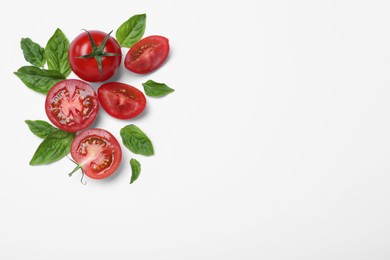 Fresh basil leaves and tomatoes on white background, flat lay. Space for text